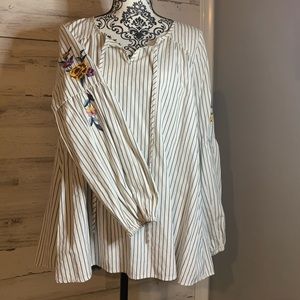 Women’s striped top with floral detail on sleeve